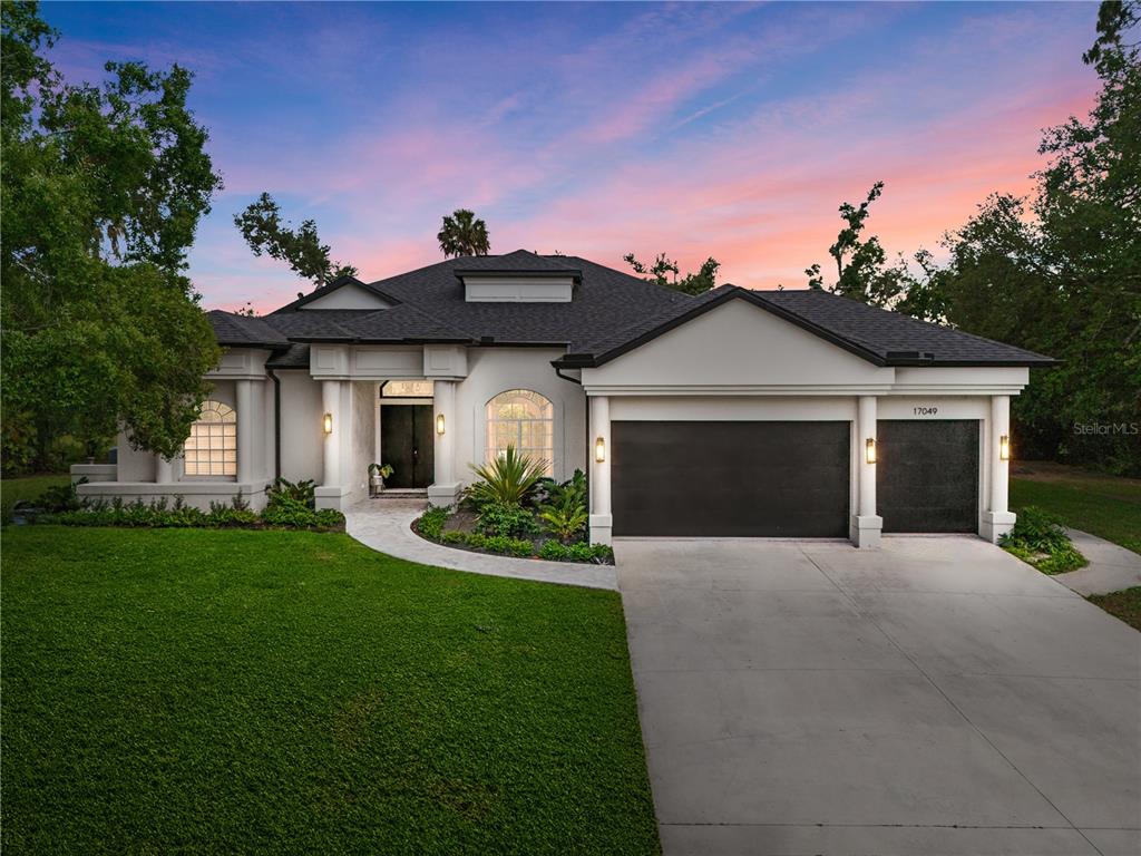 a front view of a house with a yard and garage