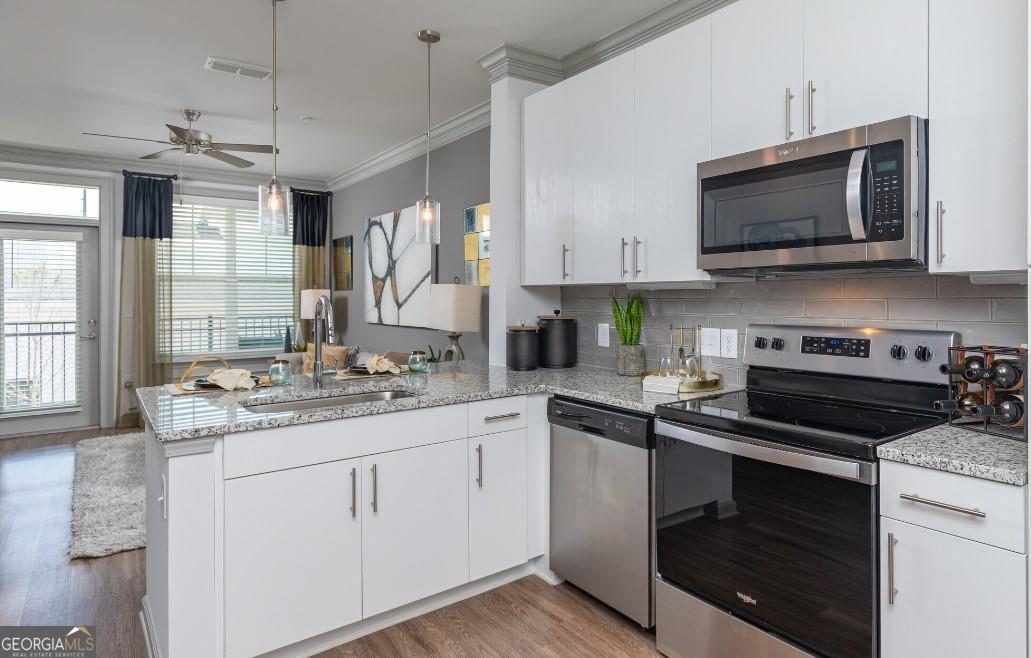 a kitchen with a sink stove and microwave