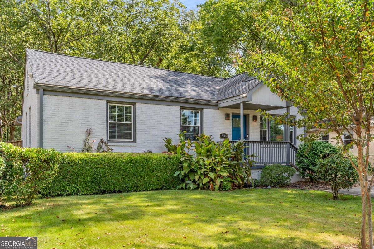 a front view of a house with a garden