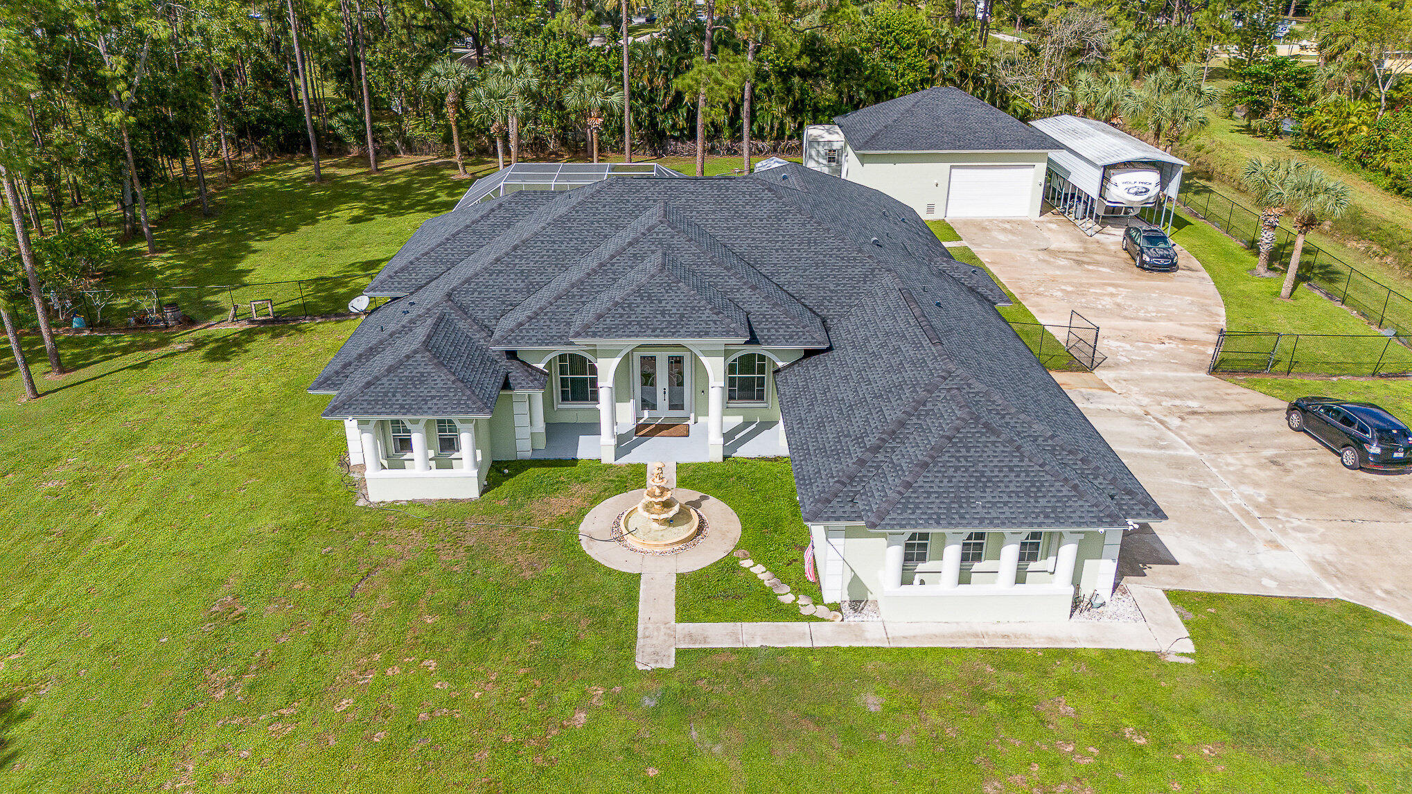 a aerial view of a house with table and chairs and garden