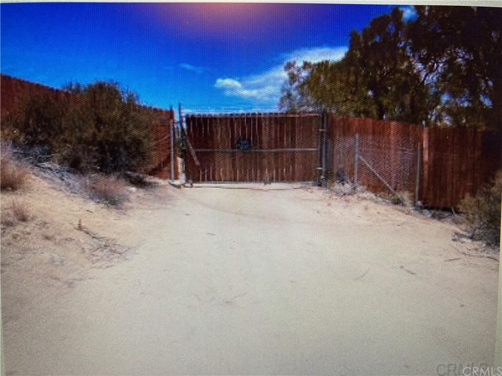 a view of backyard with wooden fence