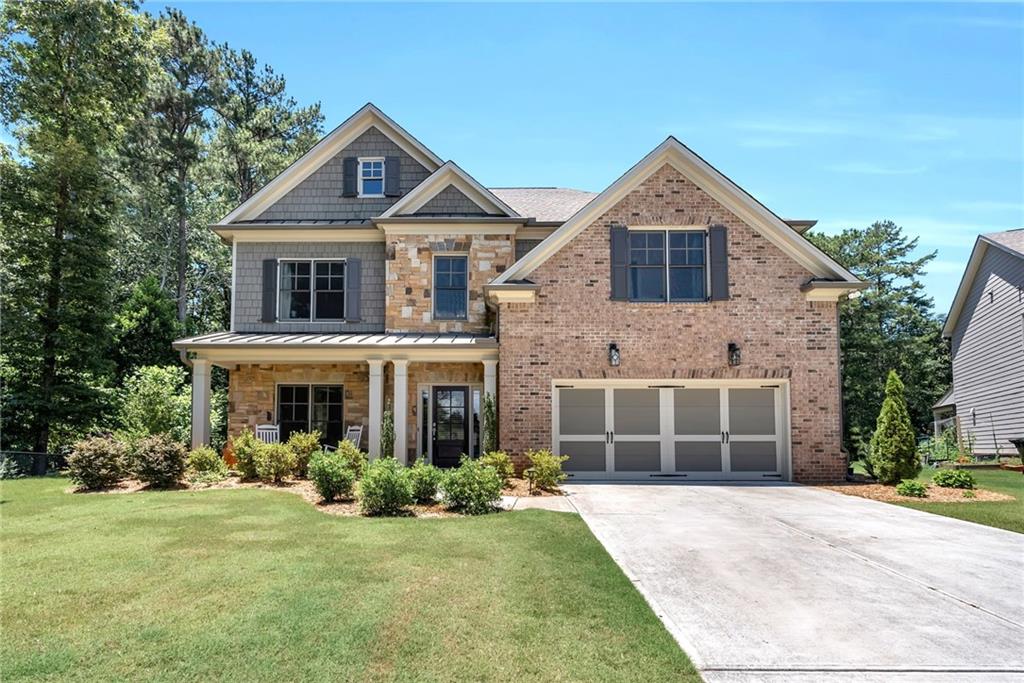 a front view of a house with a yard and garage