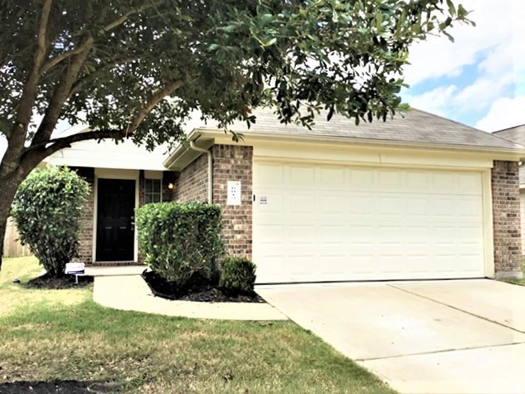 a view of a house with a tree in front of it