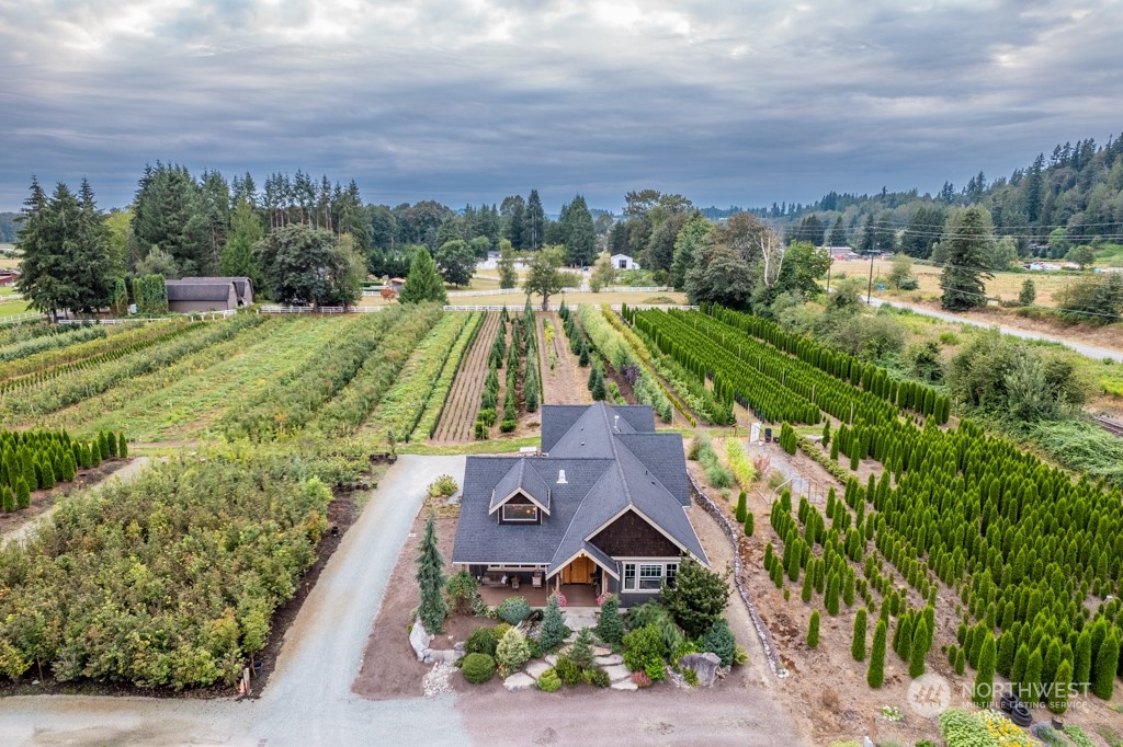 an aerial view of a house with a yard and lake view