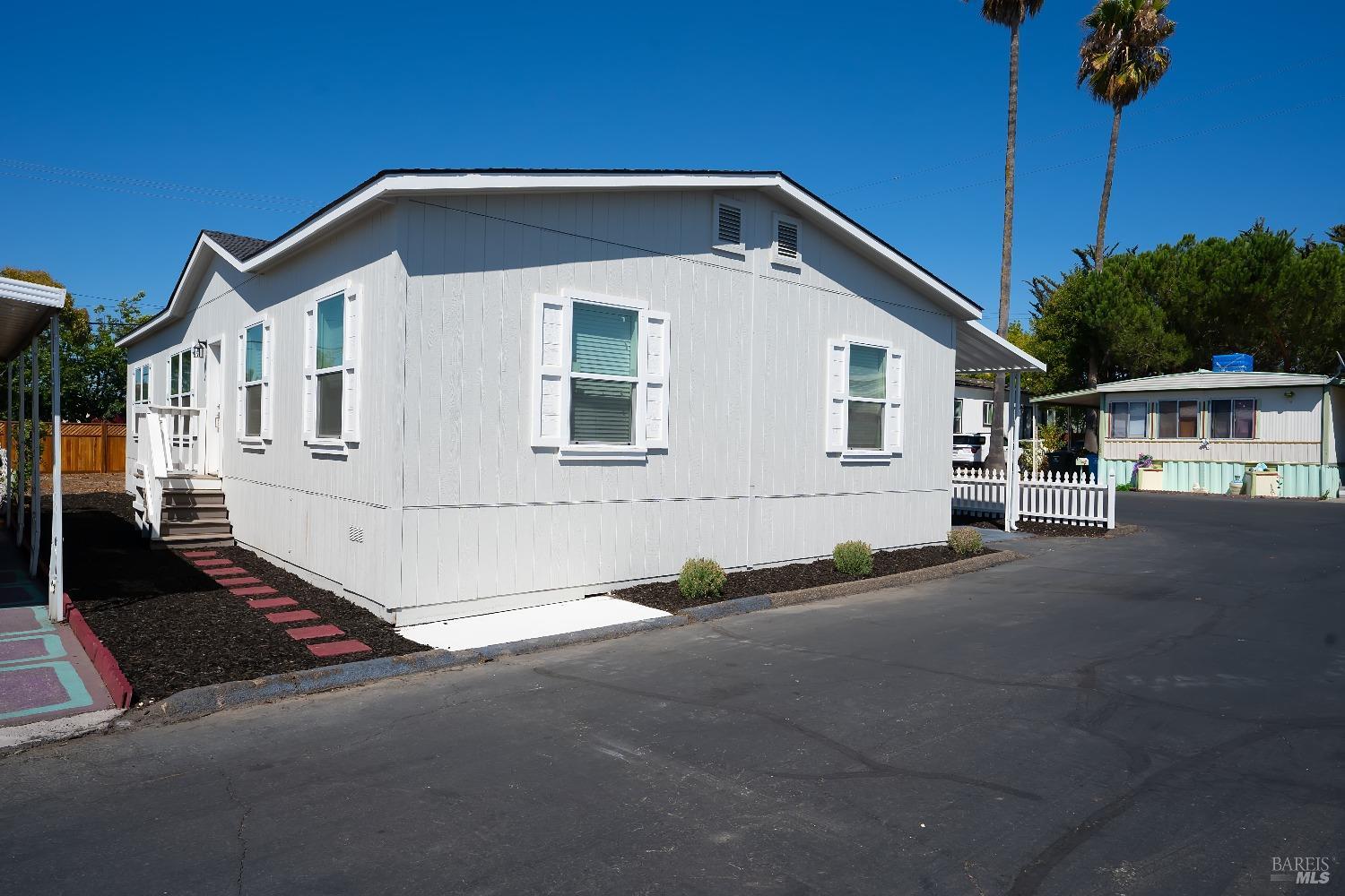 a front view of a house with a street