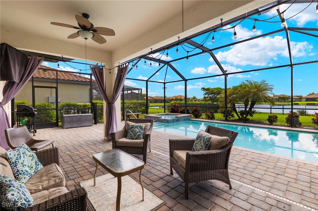 a living room with patio furniture and a floor to ceiling window