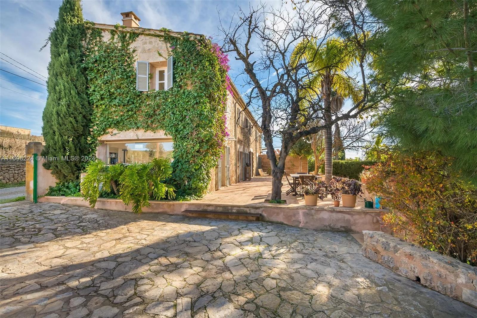 a view of a house with a tree and yard