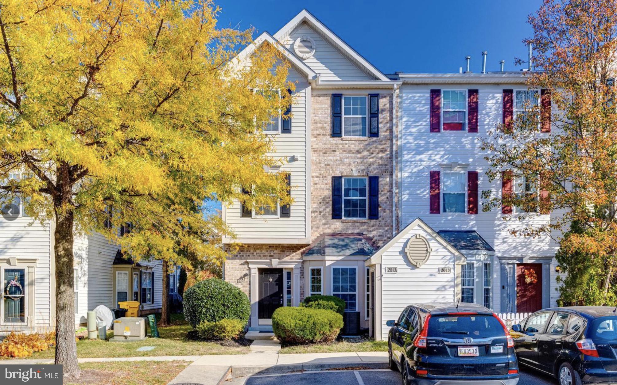 a front view of a residential apartment building with a yard