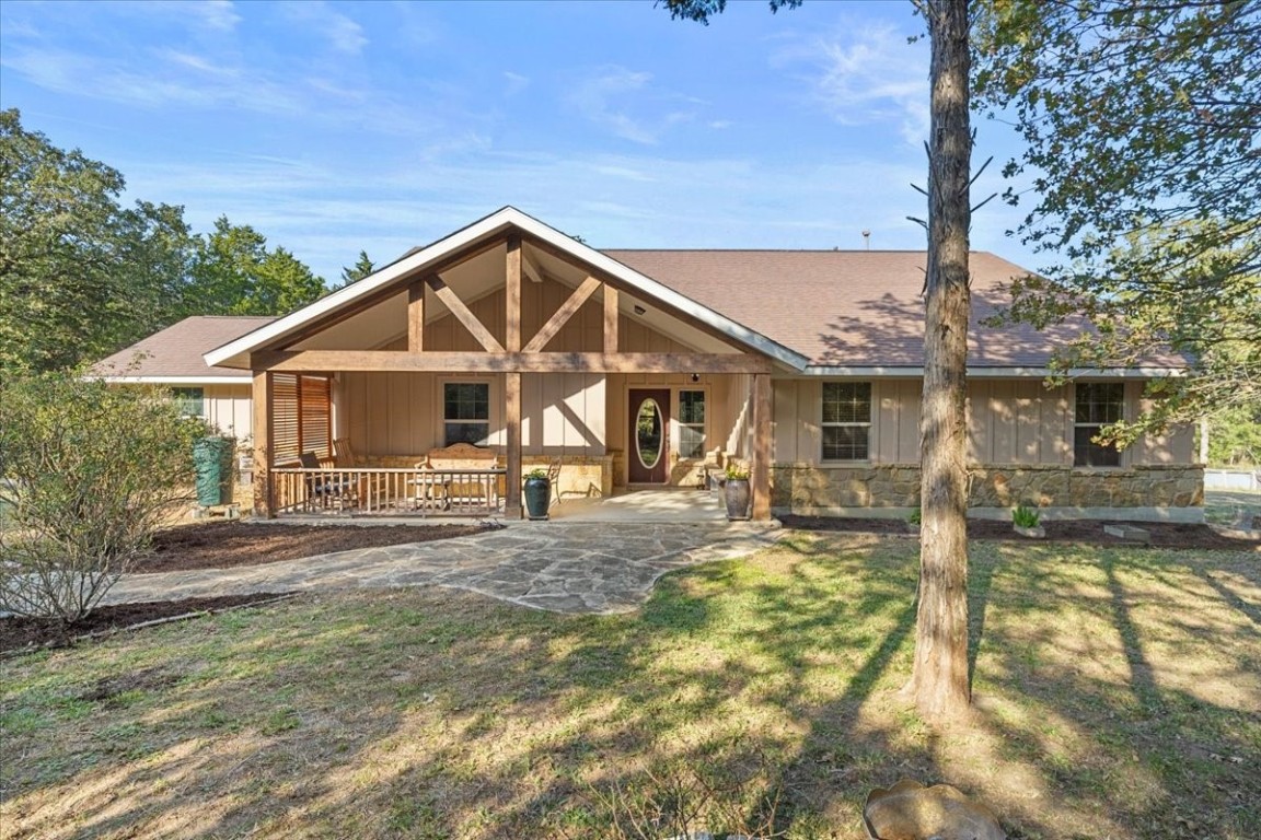 a front view of a house with a yard outdoor seating and garage