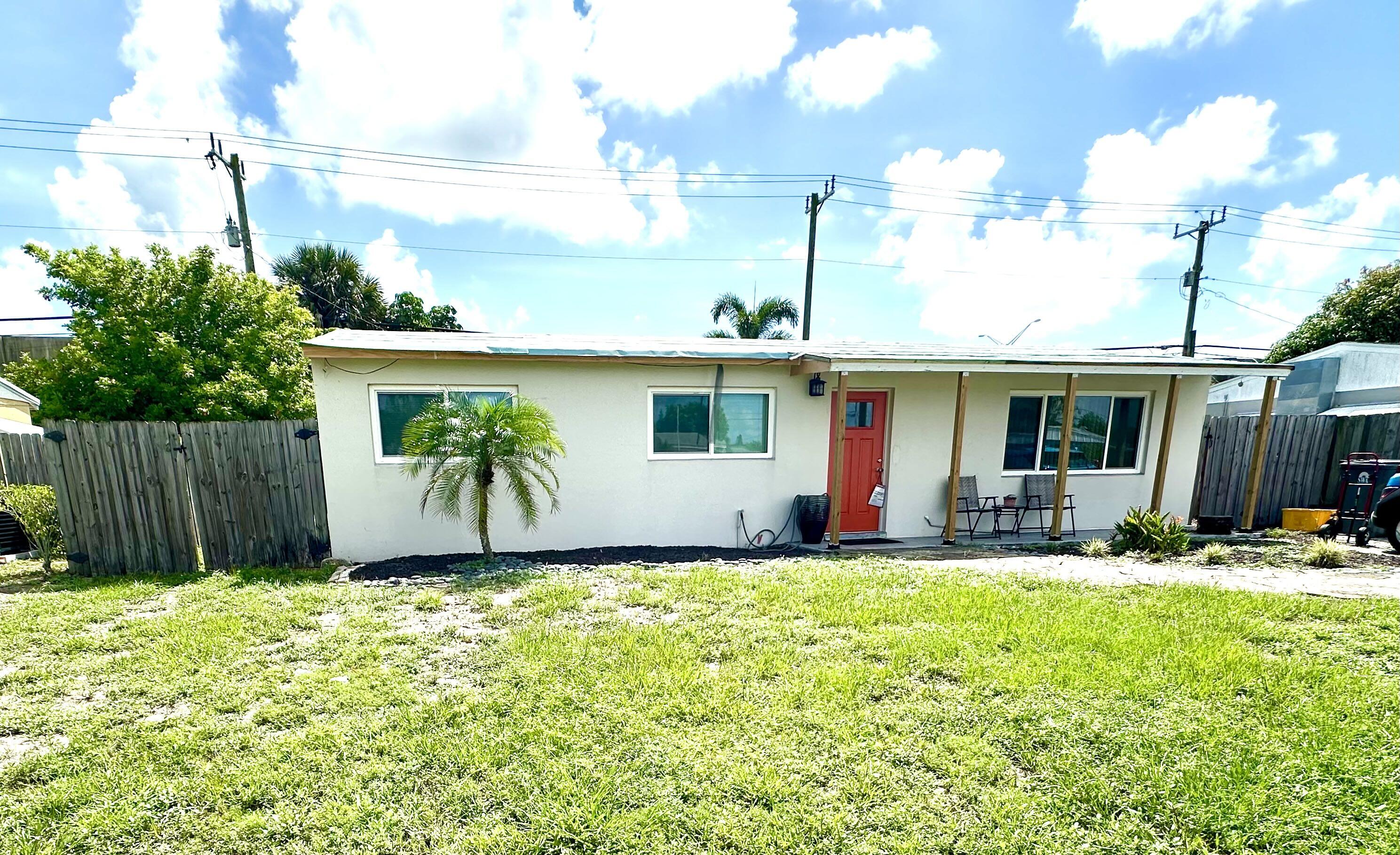 a view of a house with a yard and sitting area