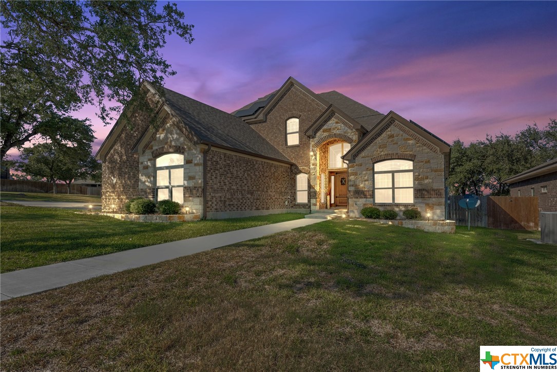 a front view of a house with a yard