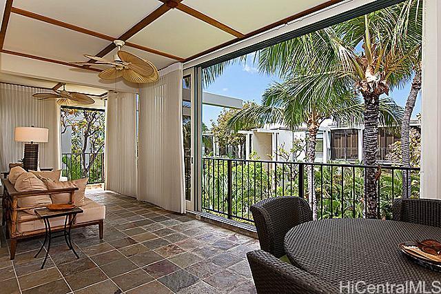 a balcony with furniture and a potted plant