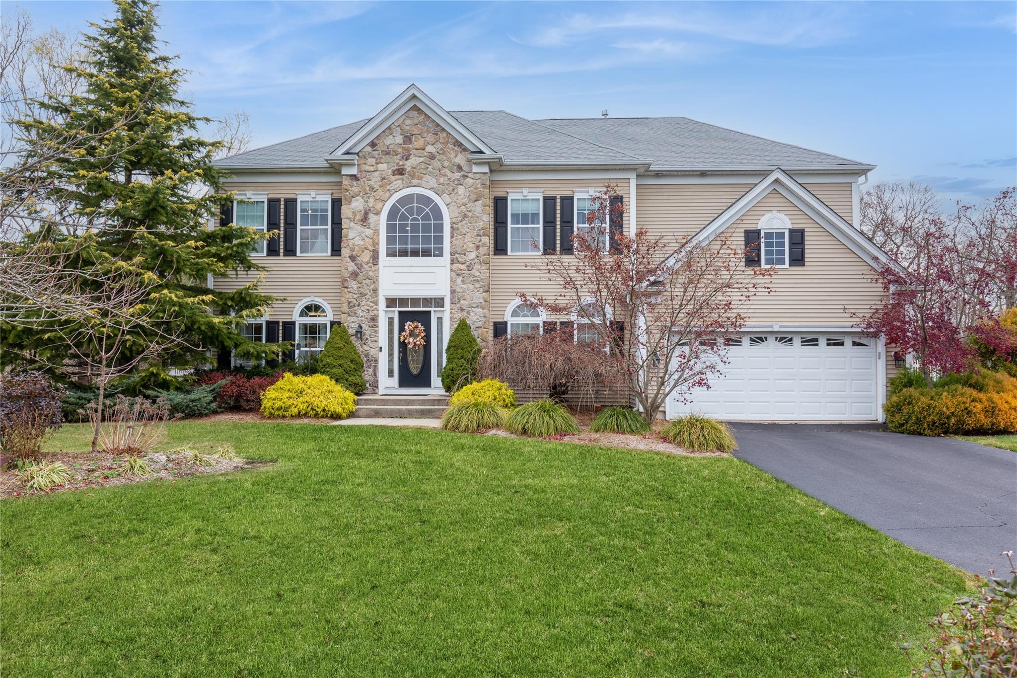 a front view of house with yard and green space