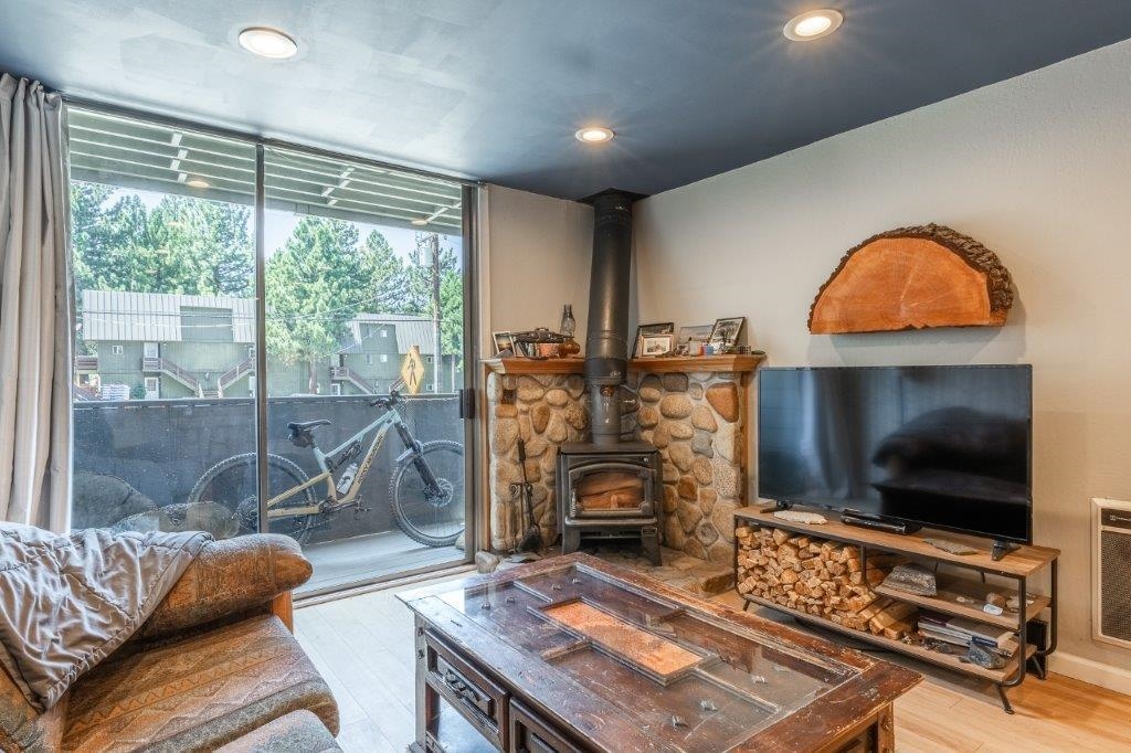 a living room with furniture a flat screen tv and a fireplace