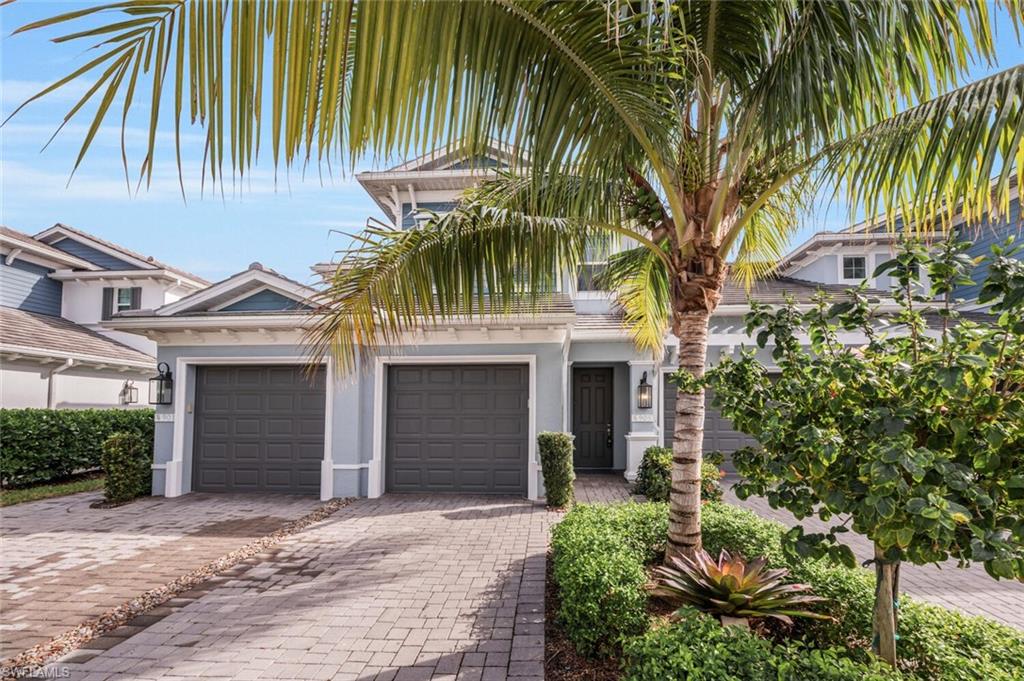 a front view of a house with a yard and a garage