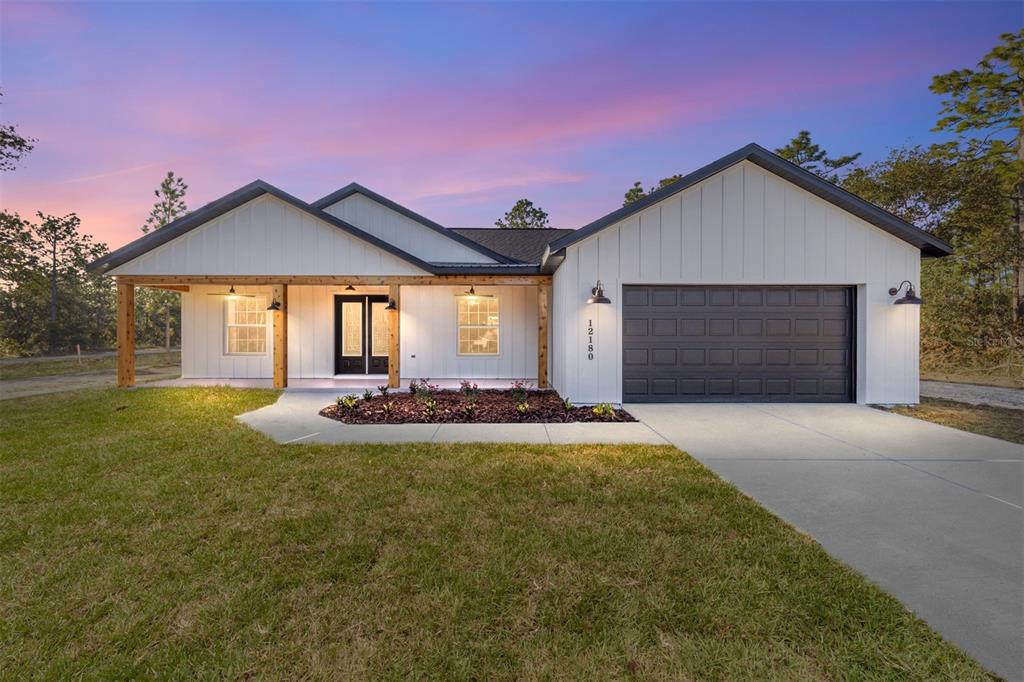 a front view of a house with yard and garage