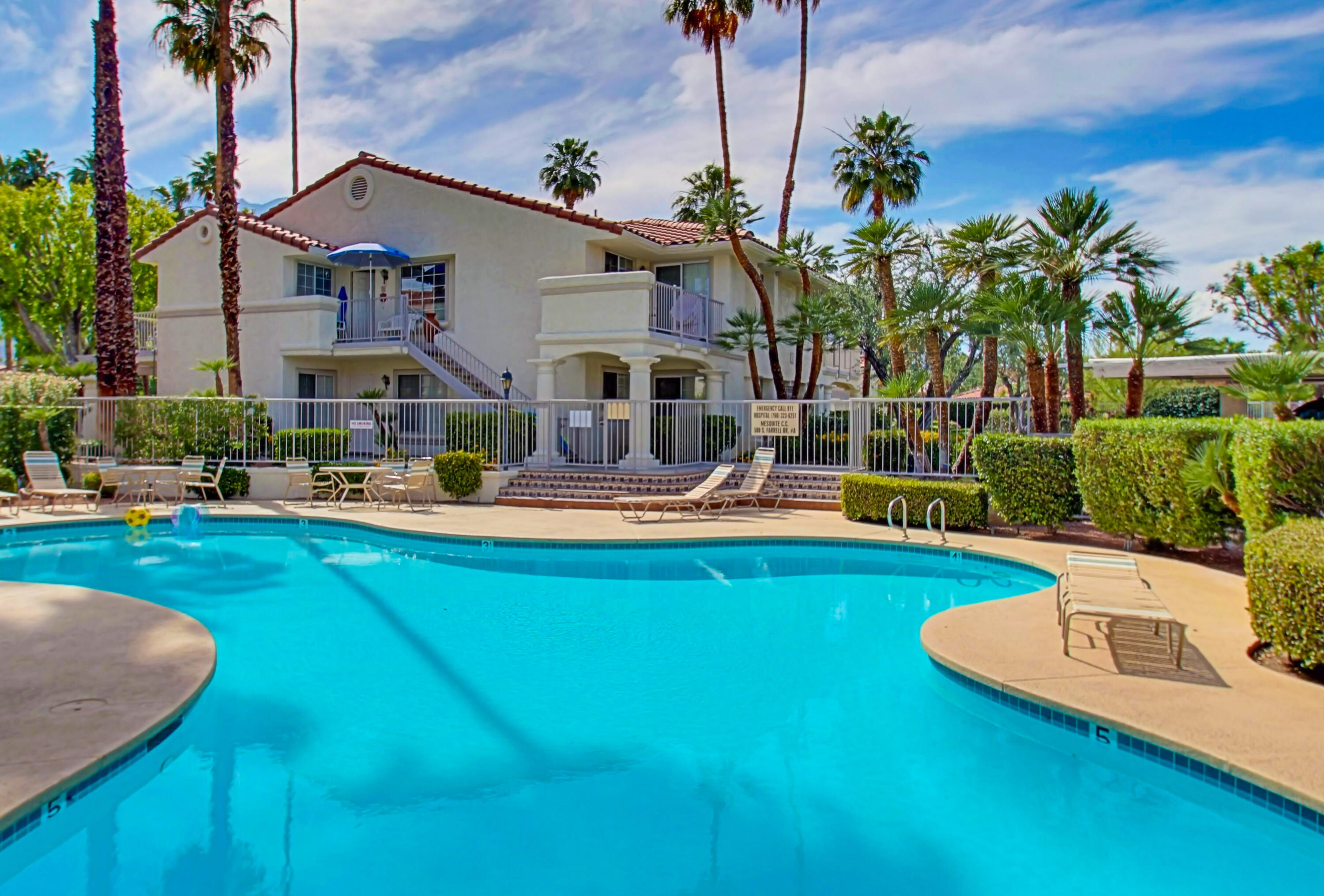 a swimming pool with outdoor seating and yard