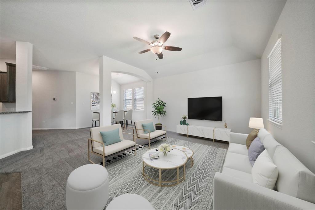 a living room with furniture and a flat screen tv