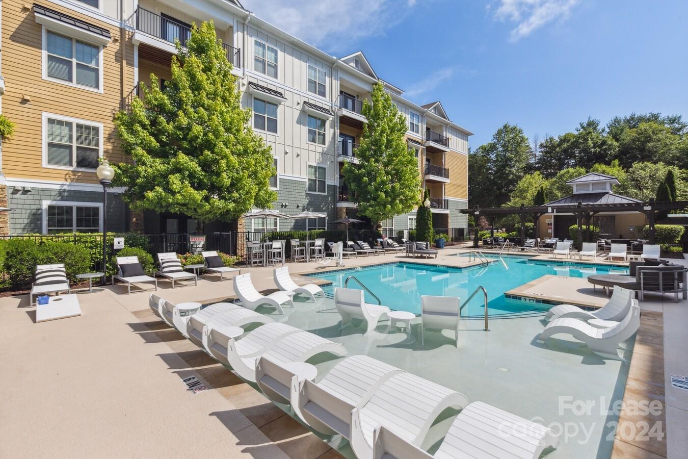 a view of a swimming pool with outdoor seating