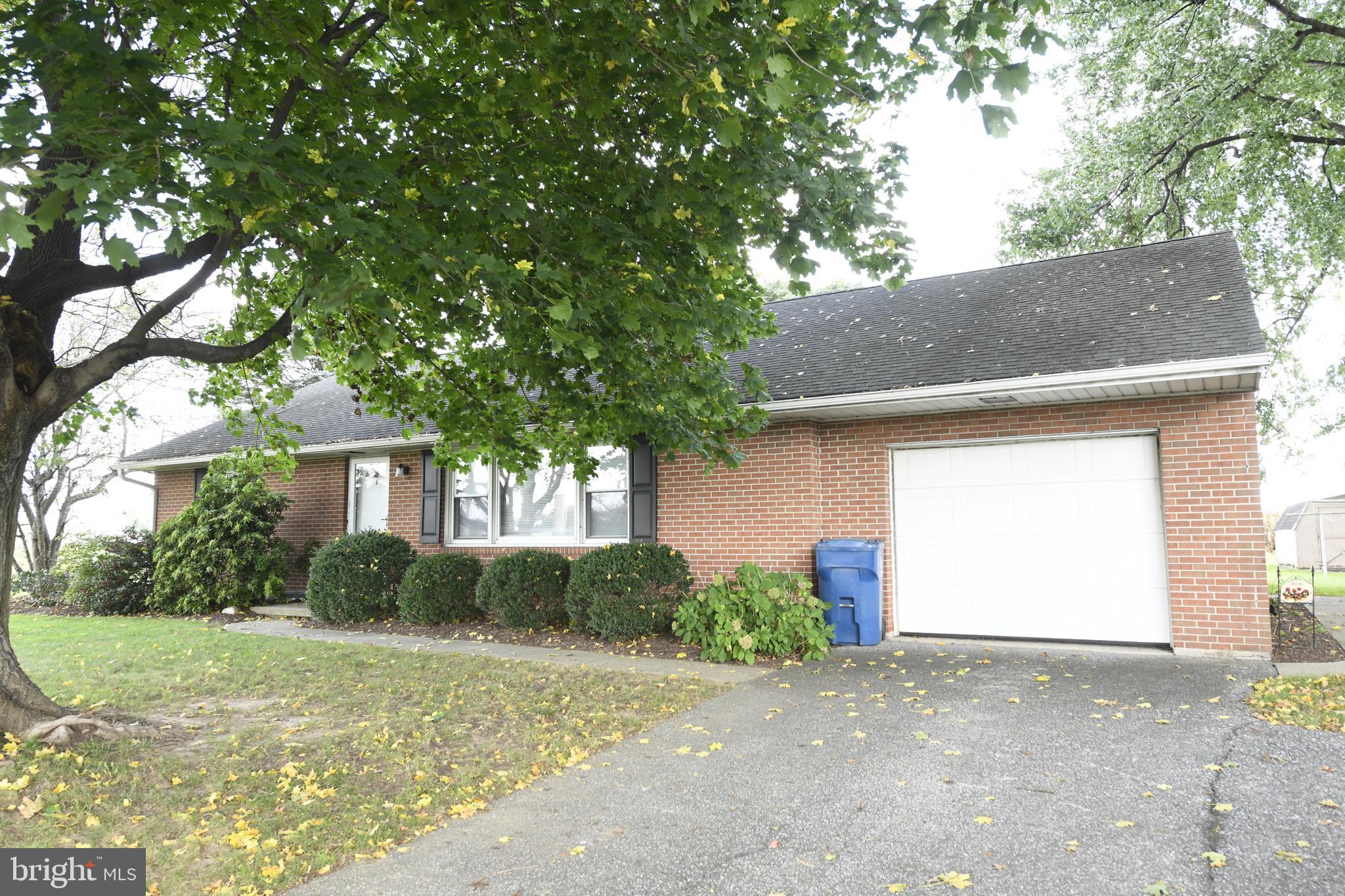 a house that has a tree in front of it