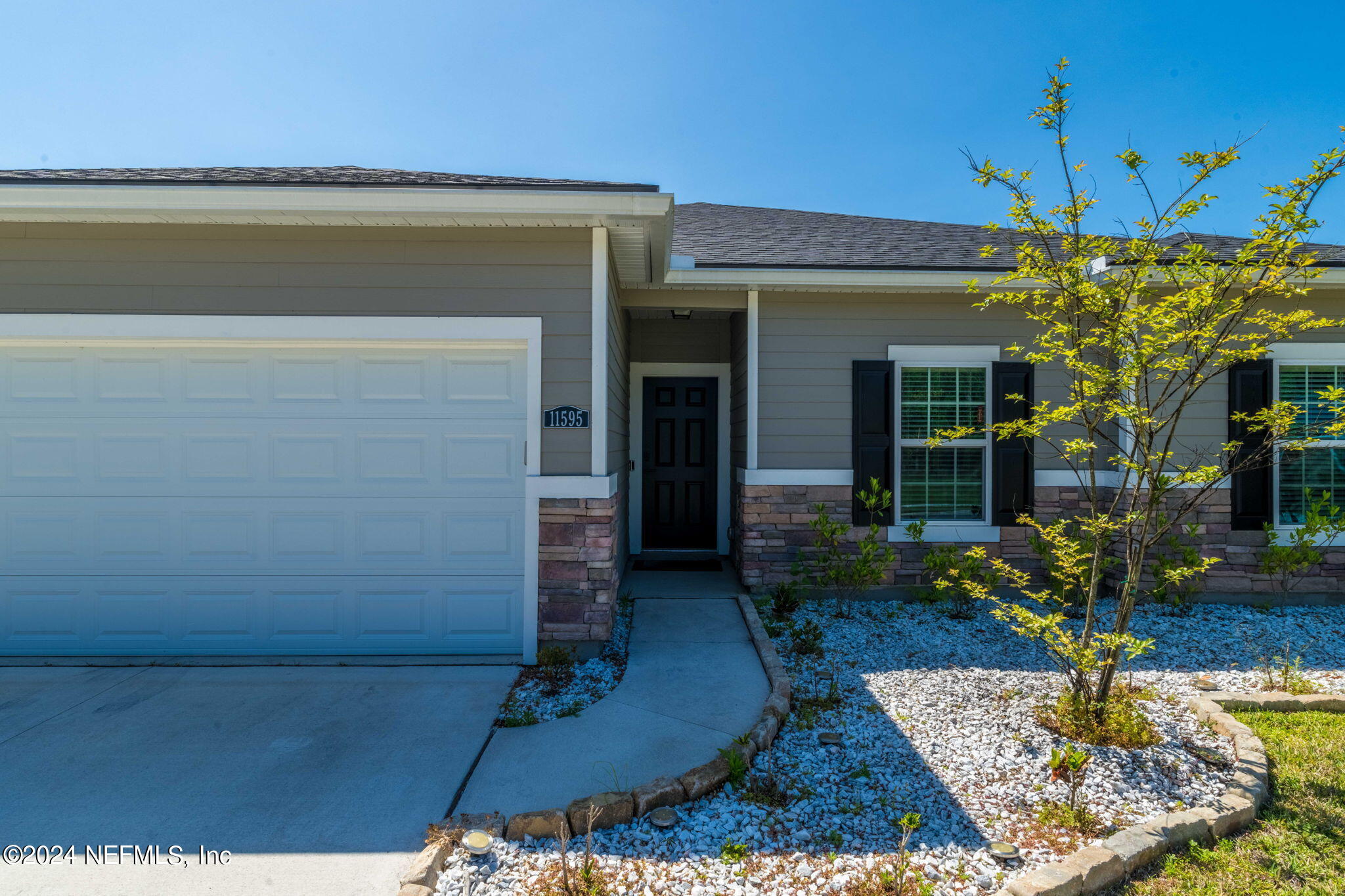 a front view of a house with garden