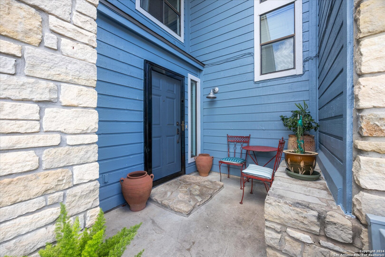 a backyard of a house with outdoor seating