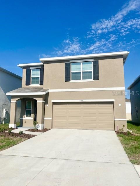 a front view of a house with garage