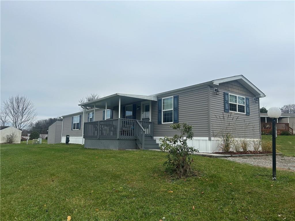 a view of a house with a yard and sitting area