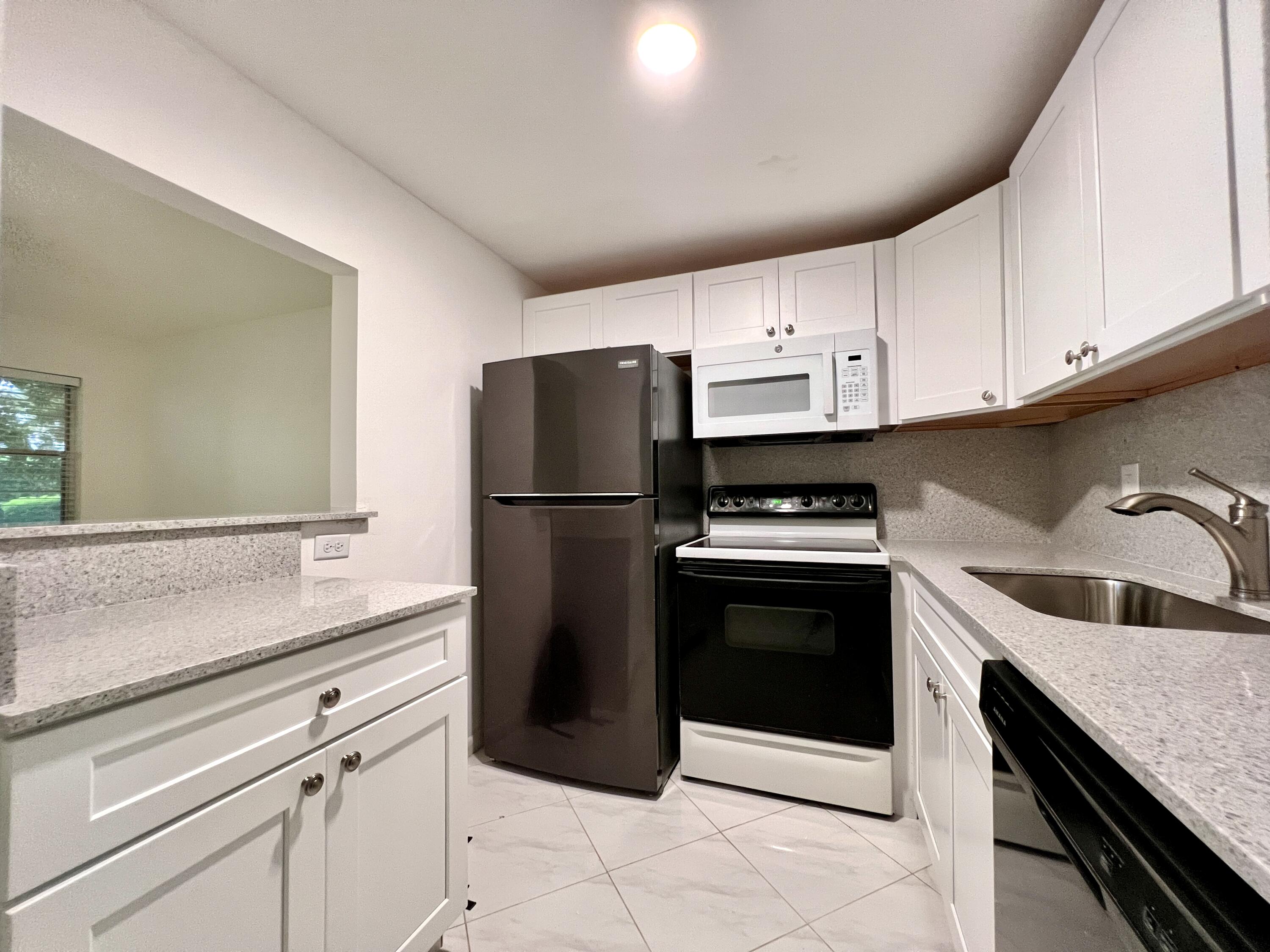 a kitchen with a sink cabinets and stainless steel appliances