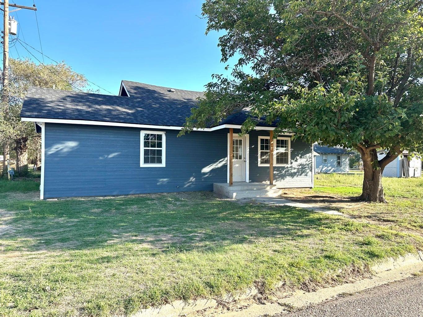 a view of a house with pool and a yard