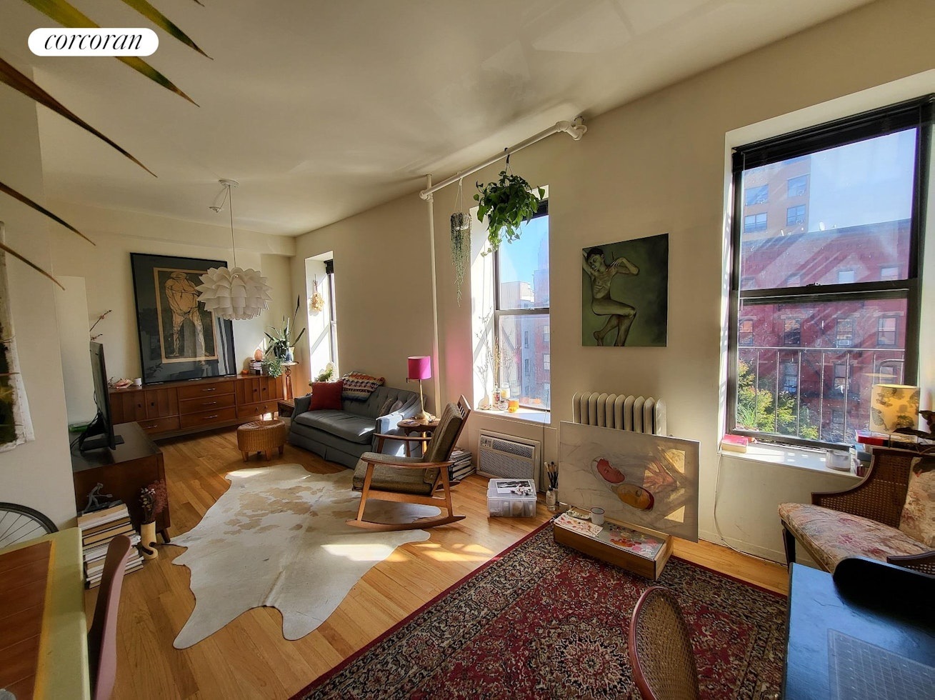 a living room with furniture rug and wooden floor