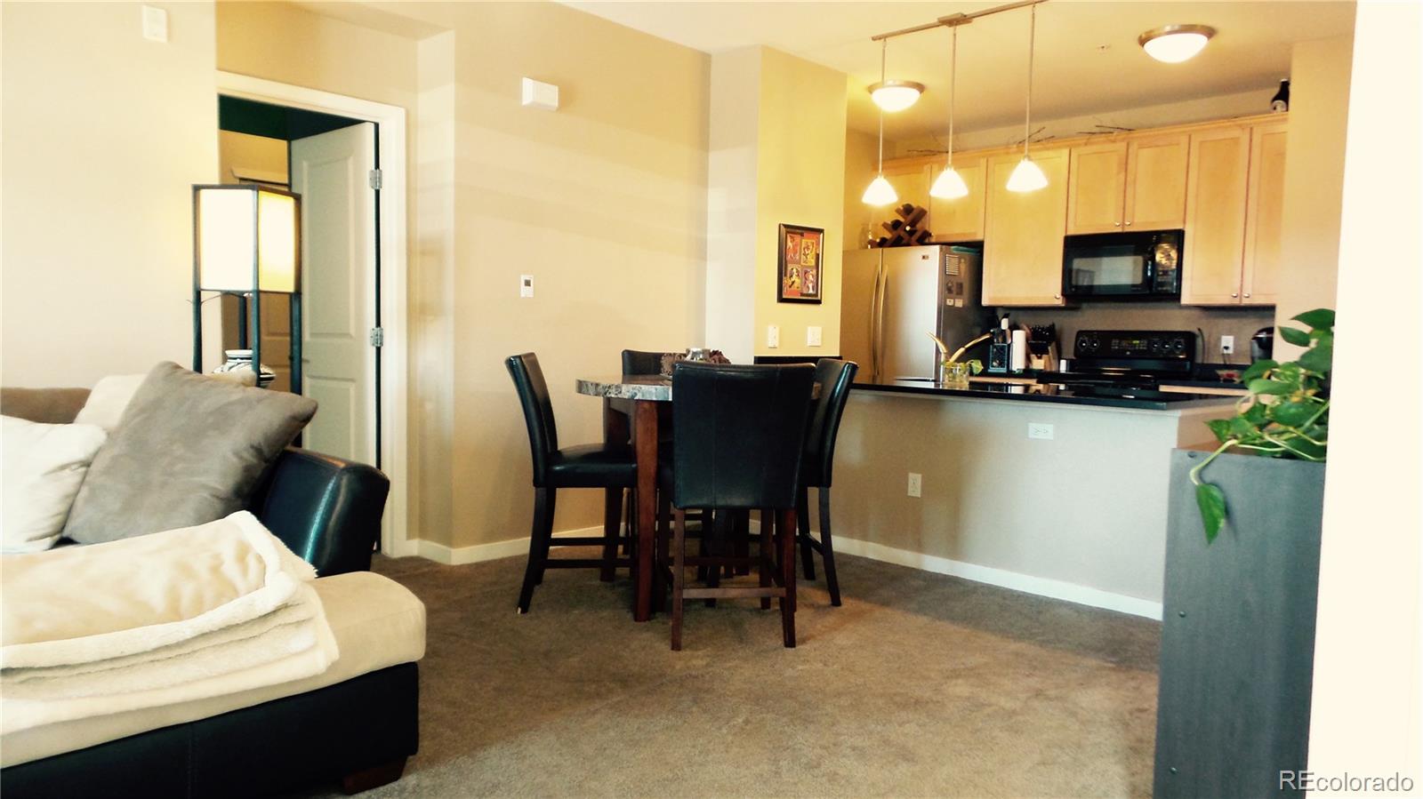 a view of a dining room with furniture and a flat screen tv