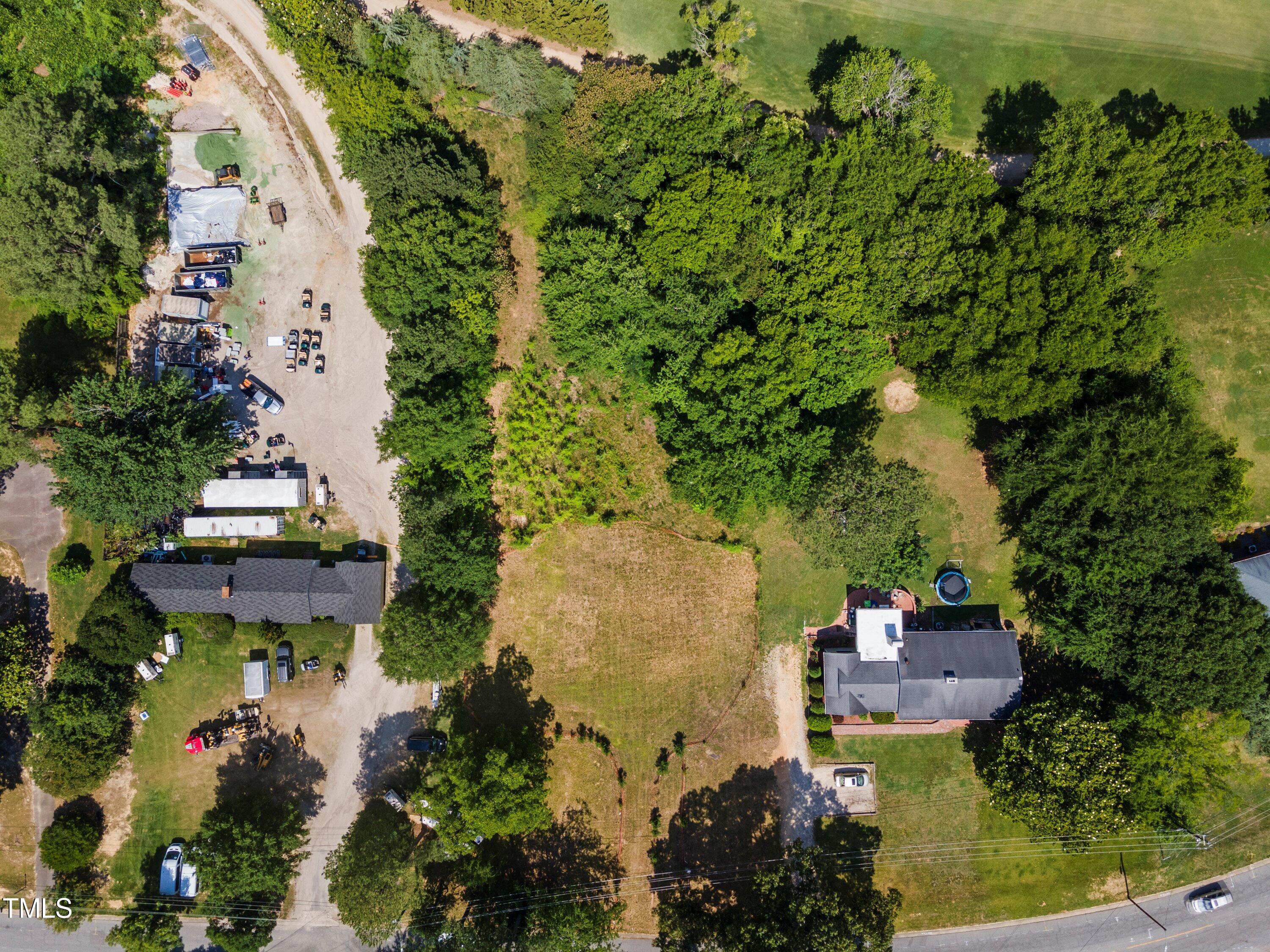 an aerial view of a house with a garden and lake view