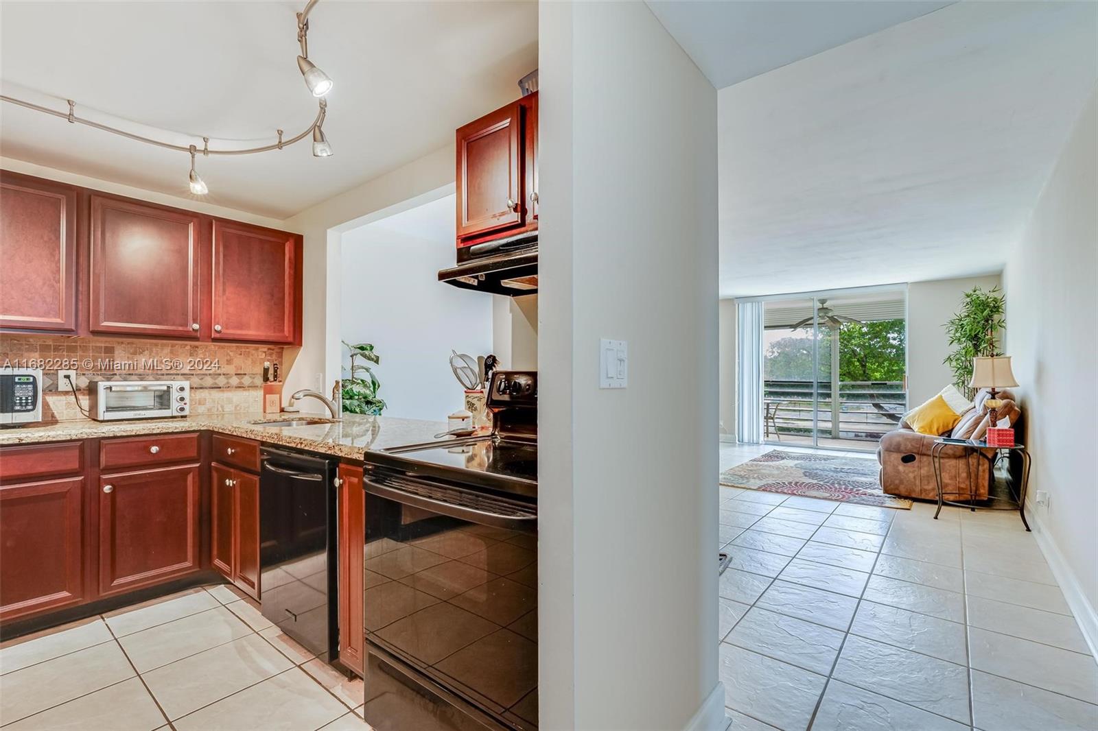 a kitchen with stainless steel appliances granite countertop a sink and cabinets