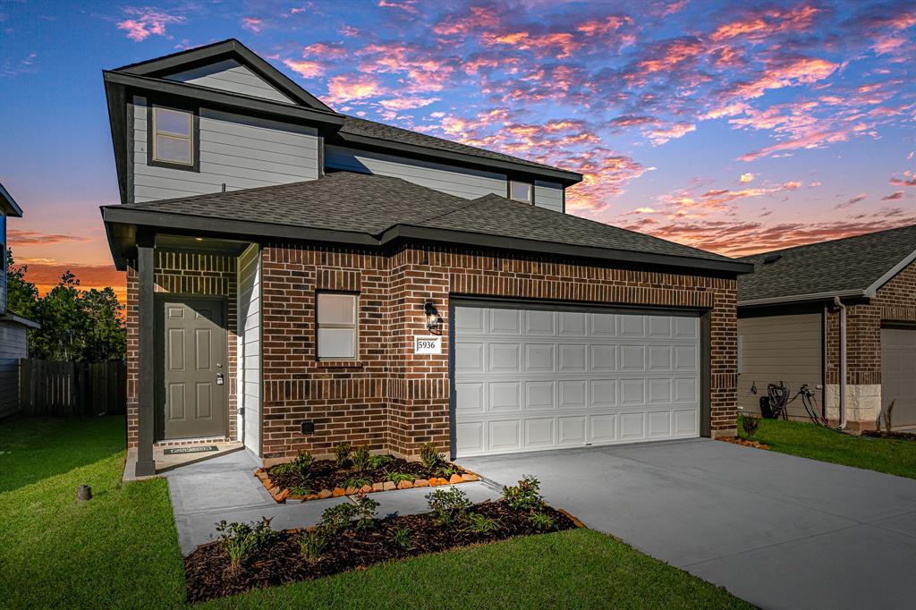 a front view of a house with a garden and entryway