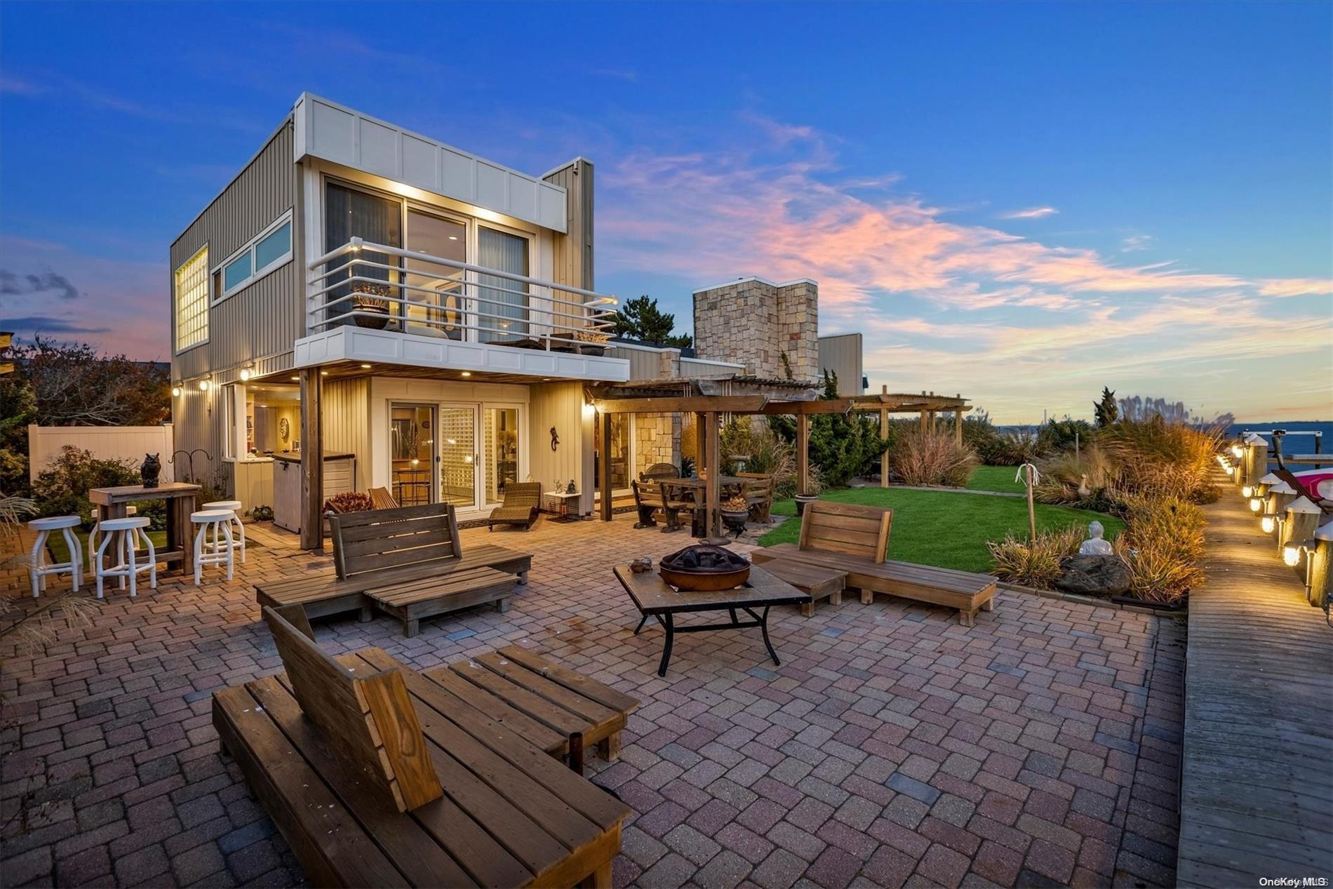 a view of a patio with couches and table and chairs with wooden fence