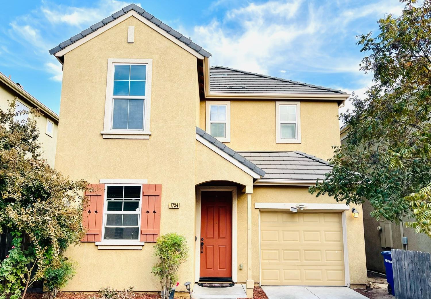 a front view of a house with a garage