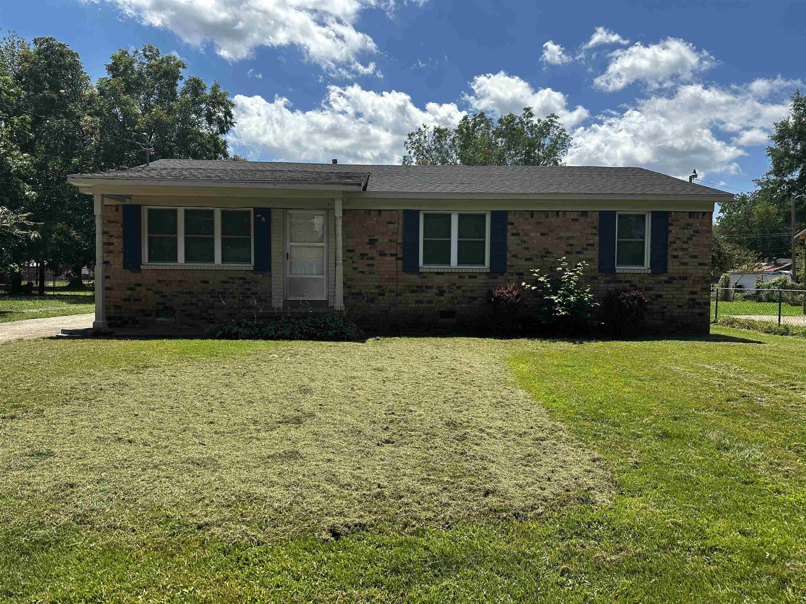 a front view of house with yard and green space