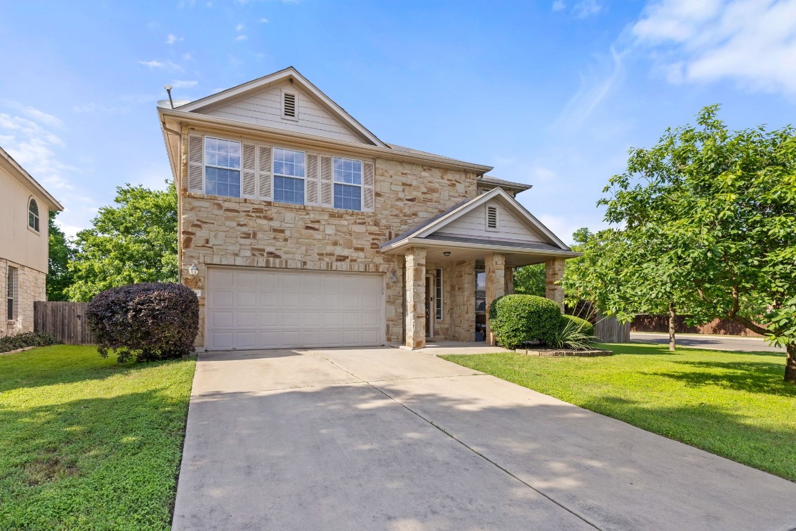 a front view of a house with a yard and garage