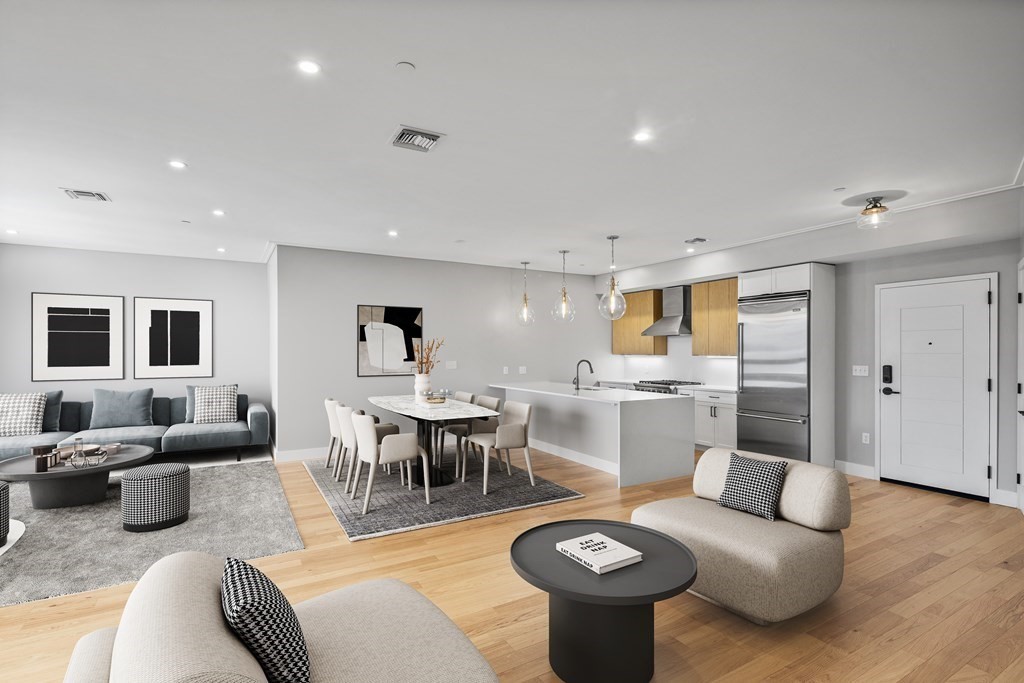 a living room with furniture and view of kitchen