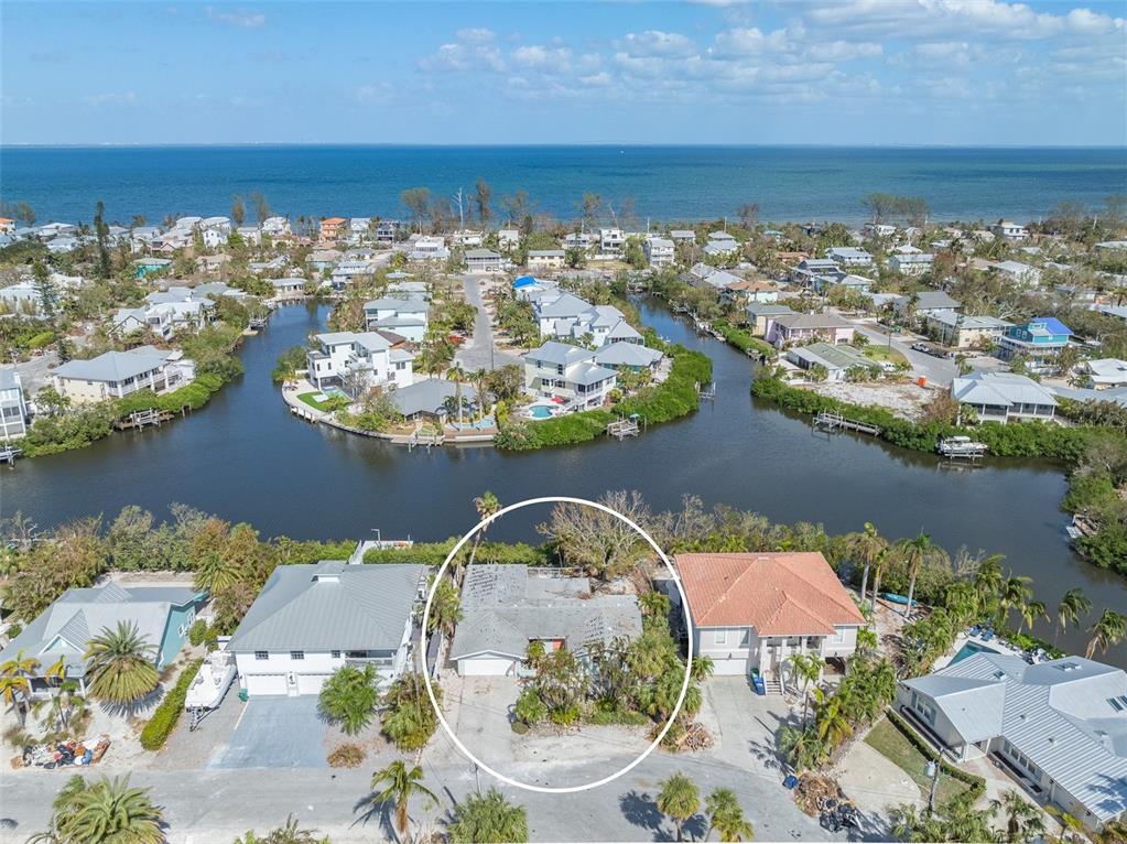 an aerial view of a house with a lake view