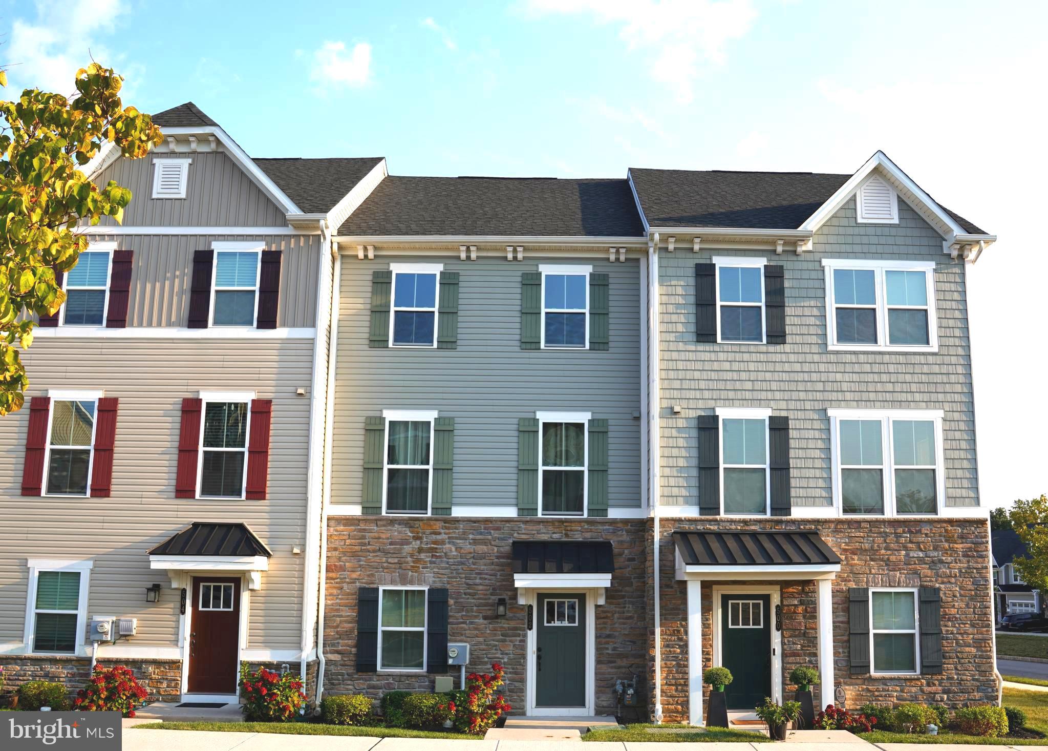 a front view of a residential apartment building with a yard