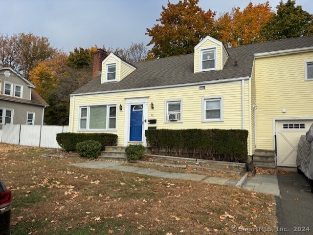 a view of a white house with a yard