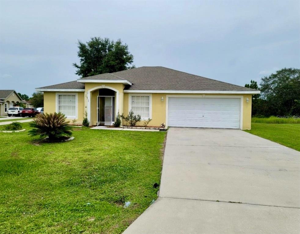 a front view of house with yard and green space