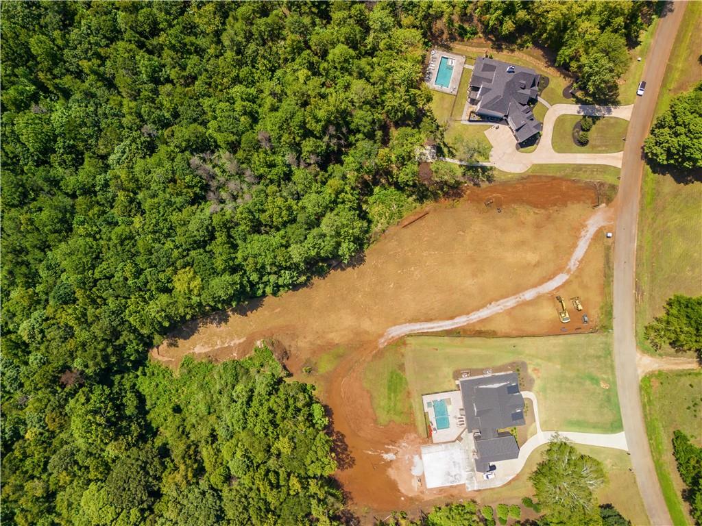 an aerial view of residential house with outdoor space and trees