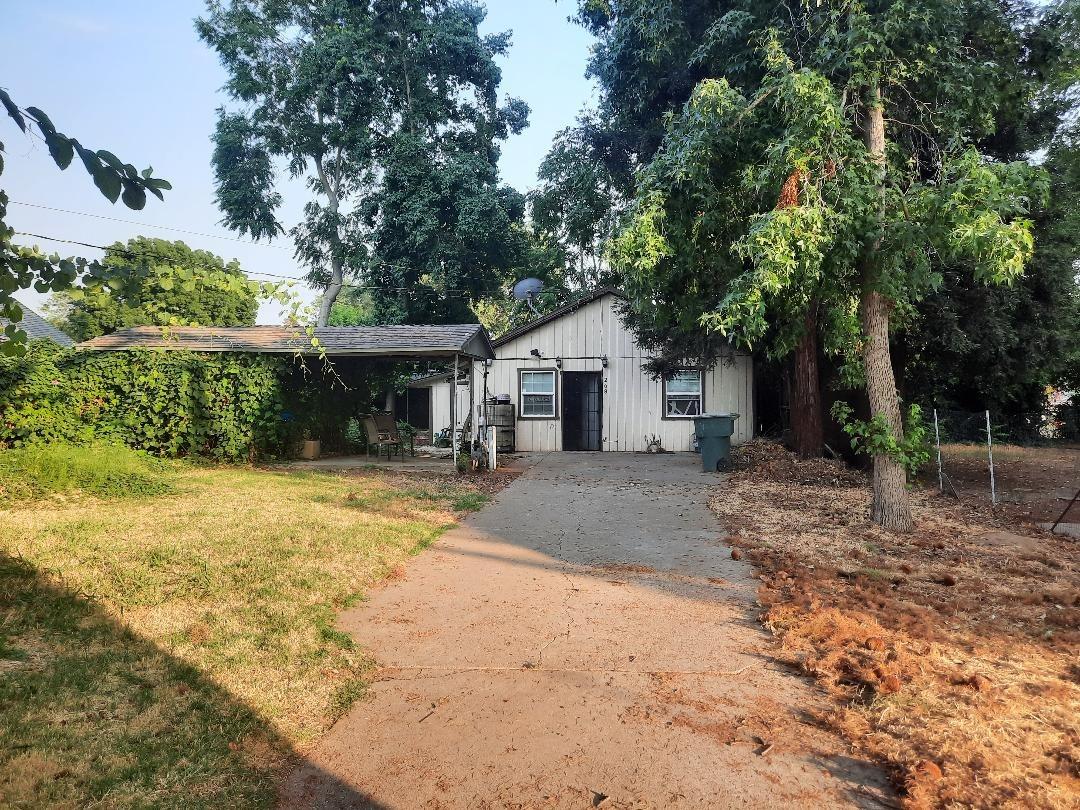 a front view of a house with a yard and shrubs