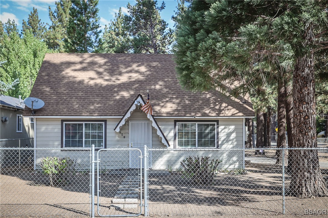 front view of a house with a tree