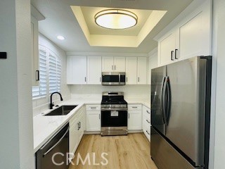 a kitchen with granite countertop a refrigerator stove and sink