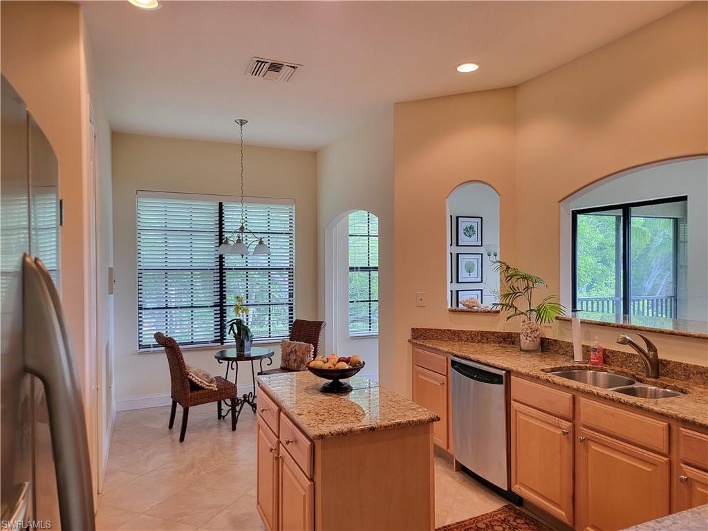 a kitchen with stainless steel appliances granite countertop sink stove and refrigerator