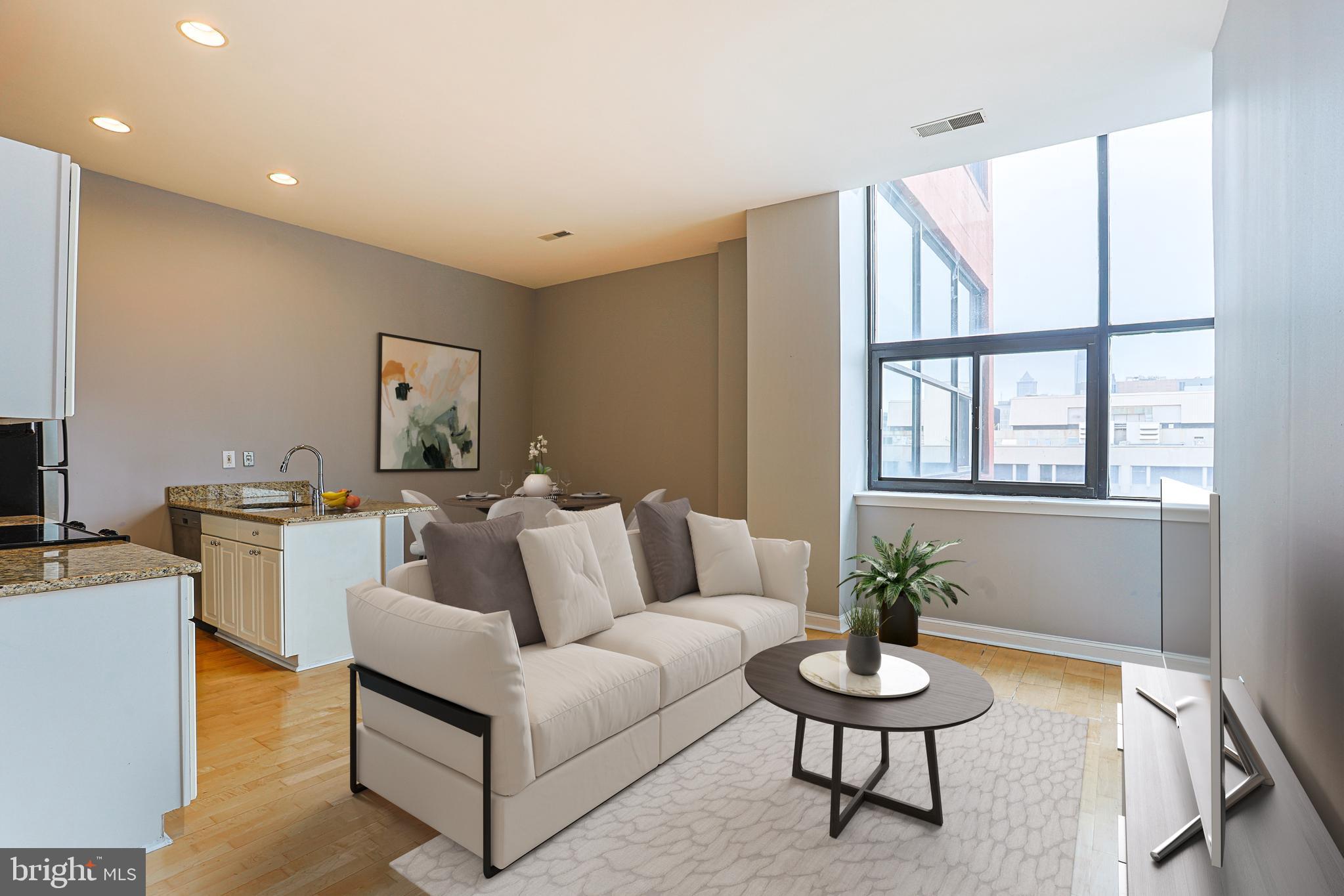 a living room with furniture and a potted plant